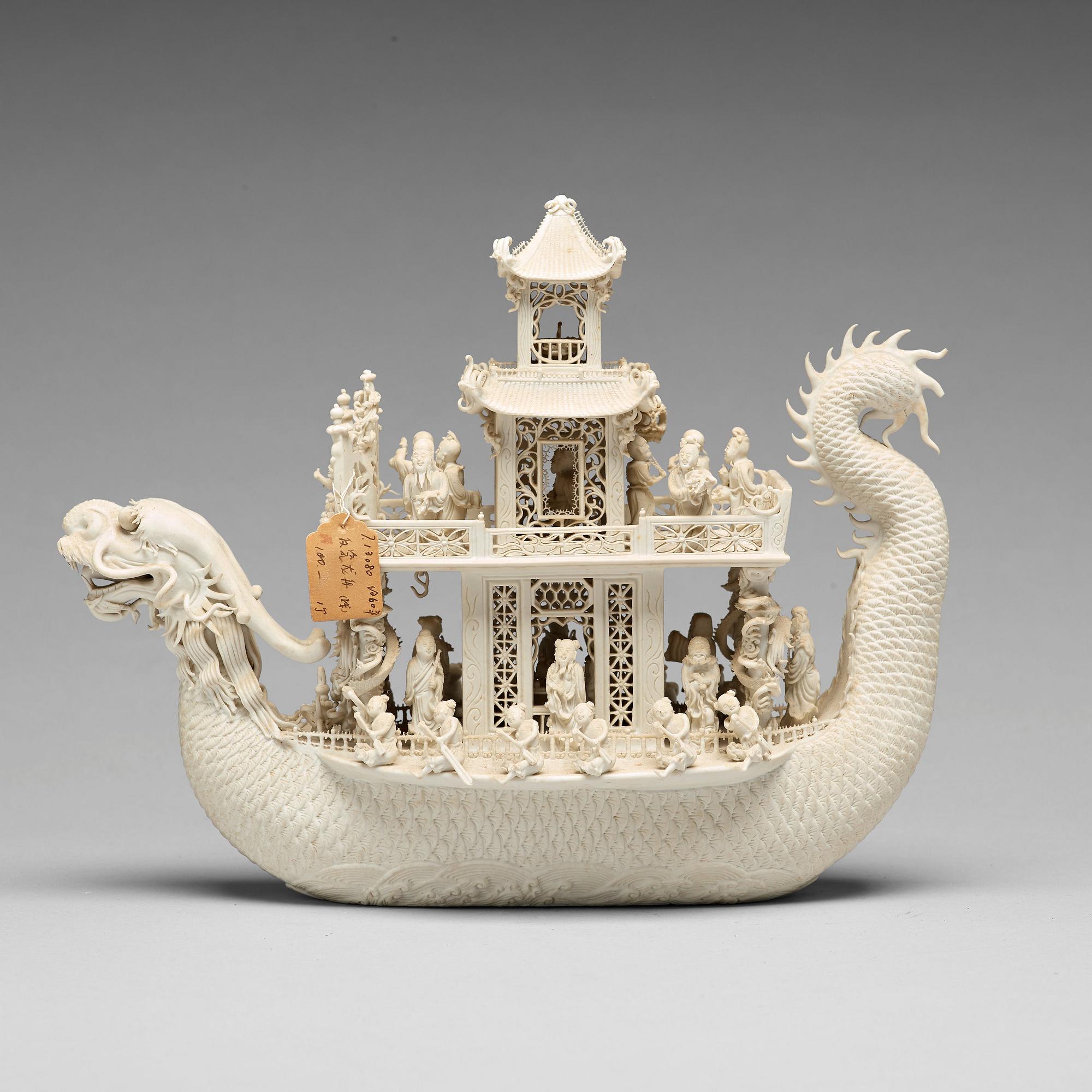 A biscuit porcelain dragon boat of 'Assembly of Immortals', Qing dynasty, Daoguang, signed Chen Guozhi, 19th century.
