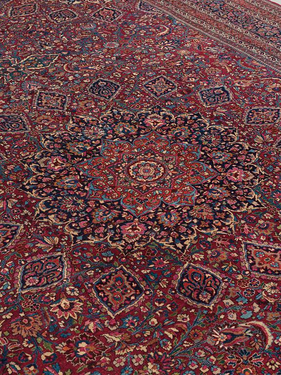 A CARPET,  a semi-antique Mashad, ca 544,5 x 356 cm, signed "Work by Makhmalbaf".