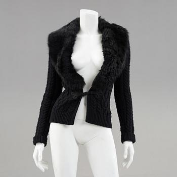 A black knitted cashmere cardiganwith fur collar by Ralph Lauren.