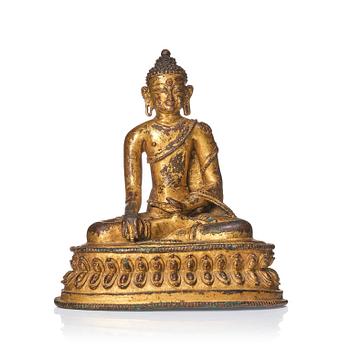 A gilt copper alloy figure of Buddha, Tibet/Nepal 15th Century.