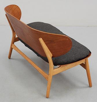 A Hans J Wegner teak and beech 'Shell' settee by Fritz Hansen, Denmark, 1950's.