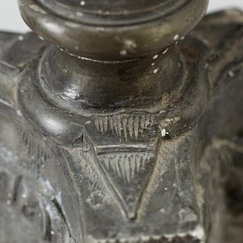 A pair of baroque pewter candlesticks, engraved date 1699.