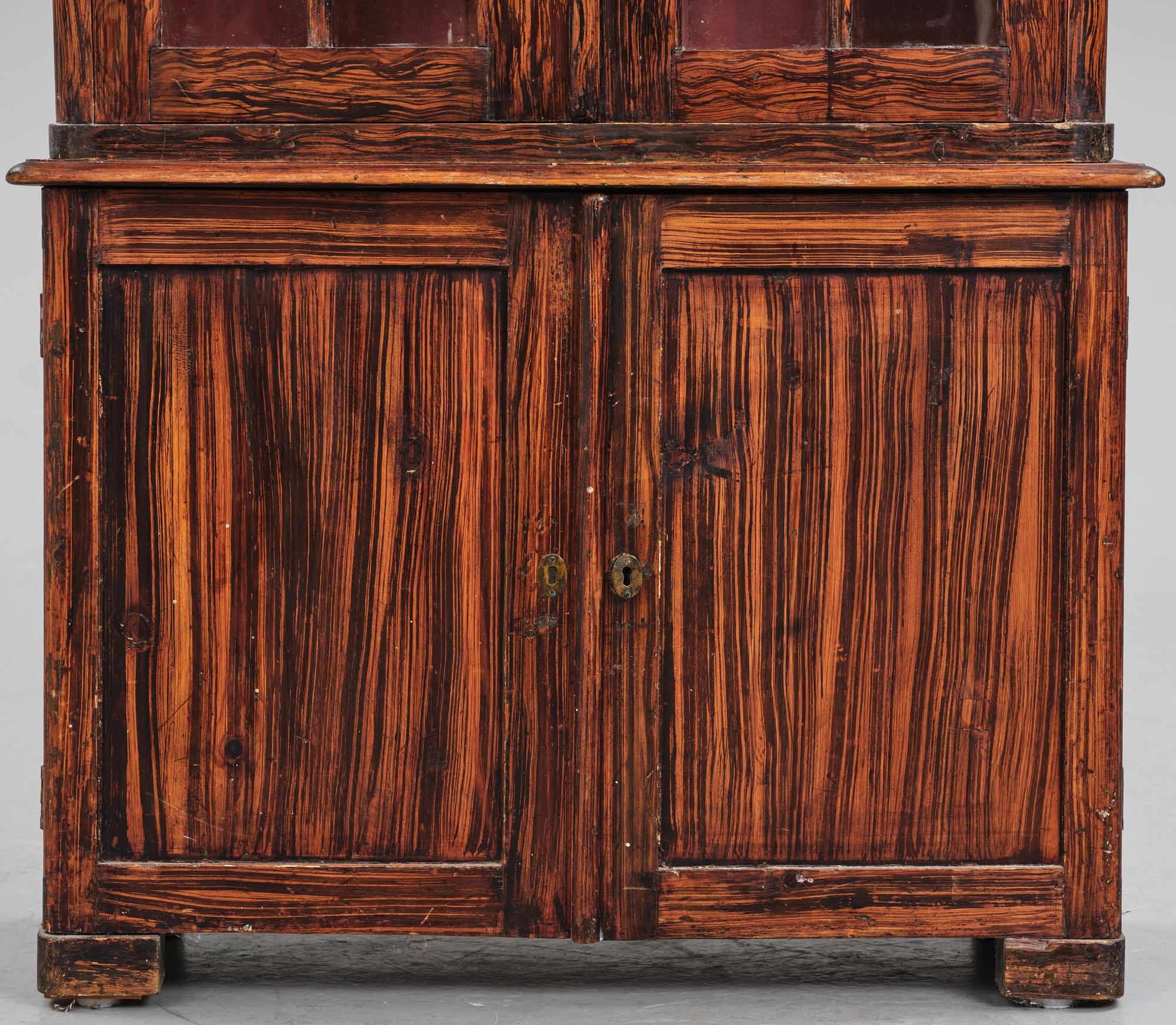 A Swedish faux-boix neo-gothic book cabinet, ca 1830.
