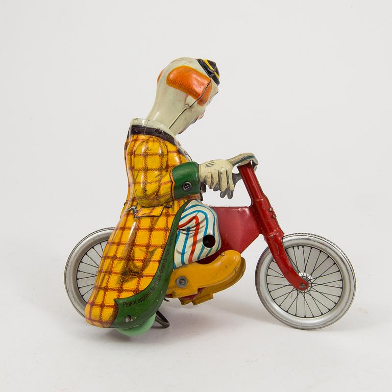 A tinplate Technofix bicycling clown Germany c. 1950.