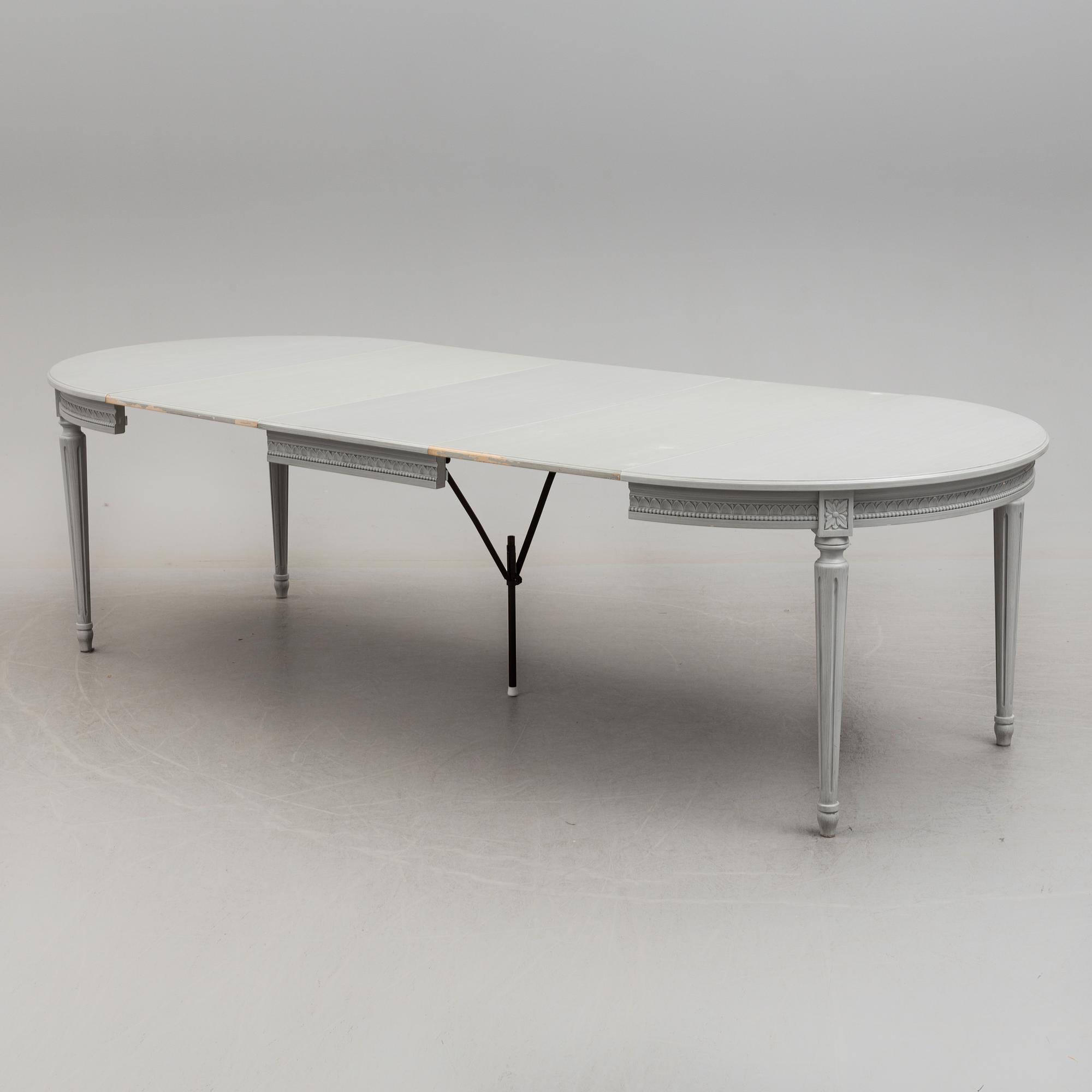 A Gustavian style dining table and ten chairs, 20th century.