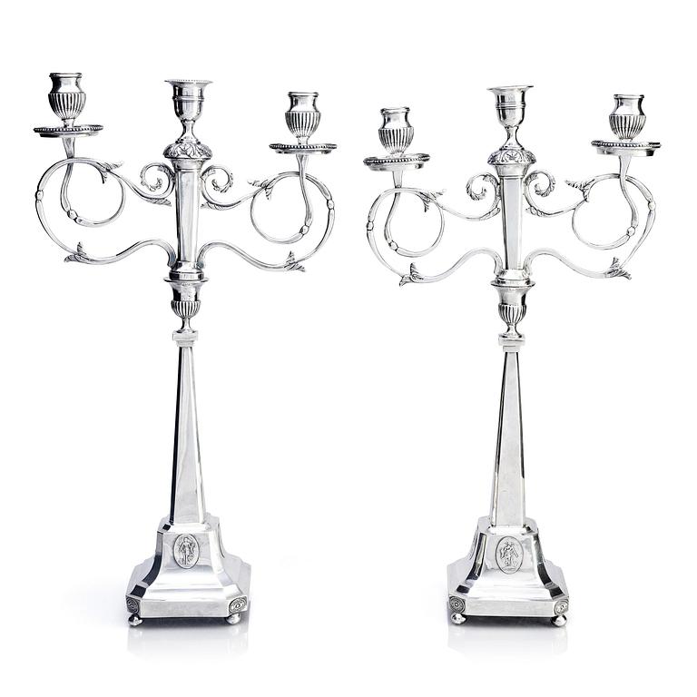 A pair of Swedish silver candelabras, marks of Pehr Zethelius, Stockholm 1797 and Daniel Hedberg, Eksjö 1829.