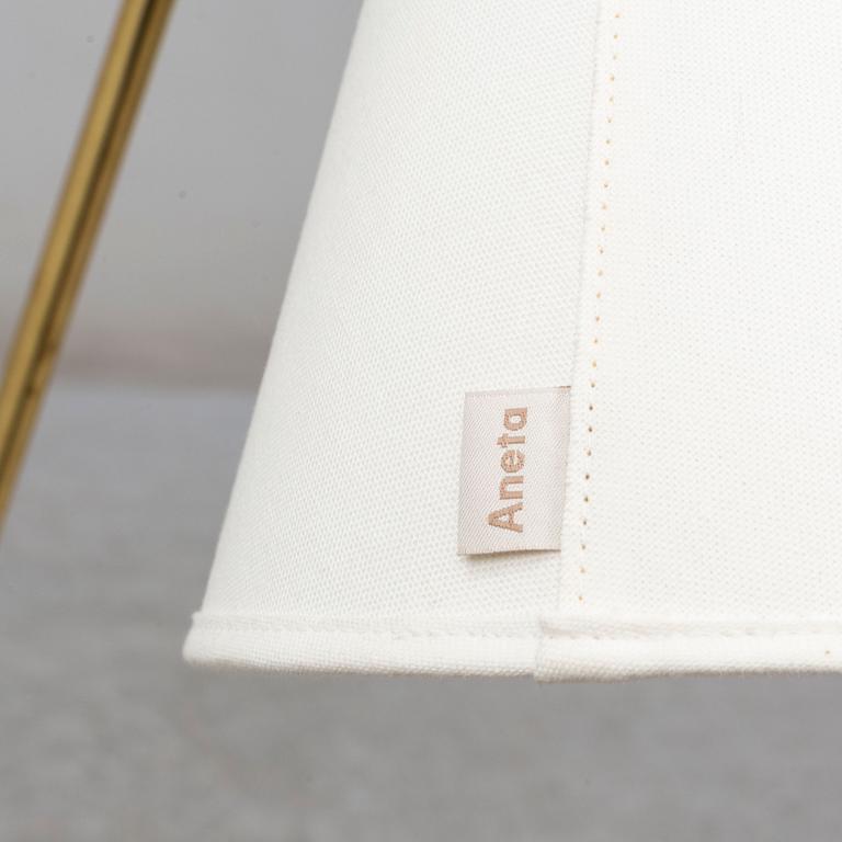 a brass and leather floor lamp from the second half of the 20th century.