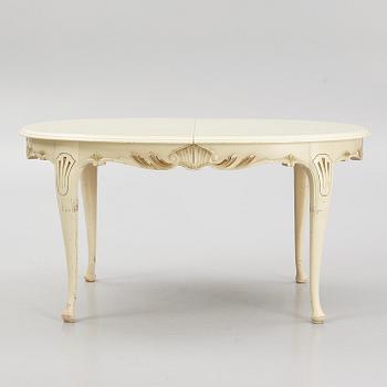 A Rococo style Dining Table with Chairs, first half of the 20th Century.