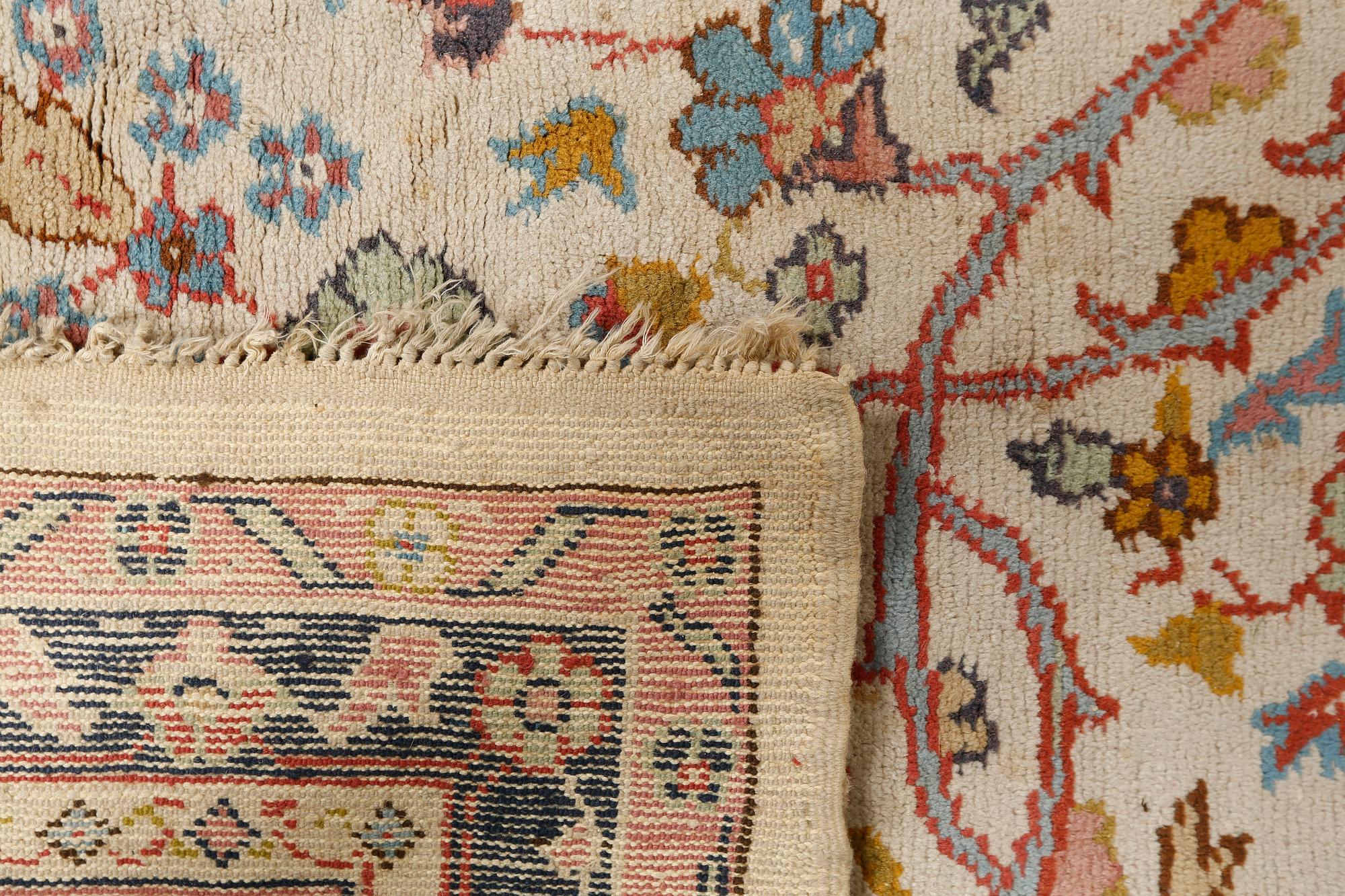 A rug from Smyrna, semi-antique, 417 x 300 cm.