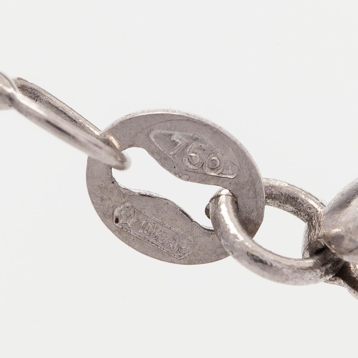 Kaulakoru, 18K valkokultaa, fasettihiottu granaatti ja timantteja.