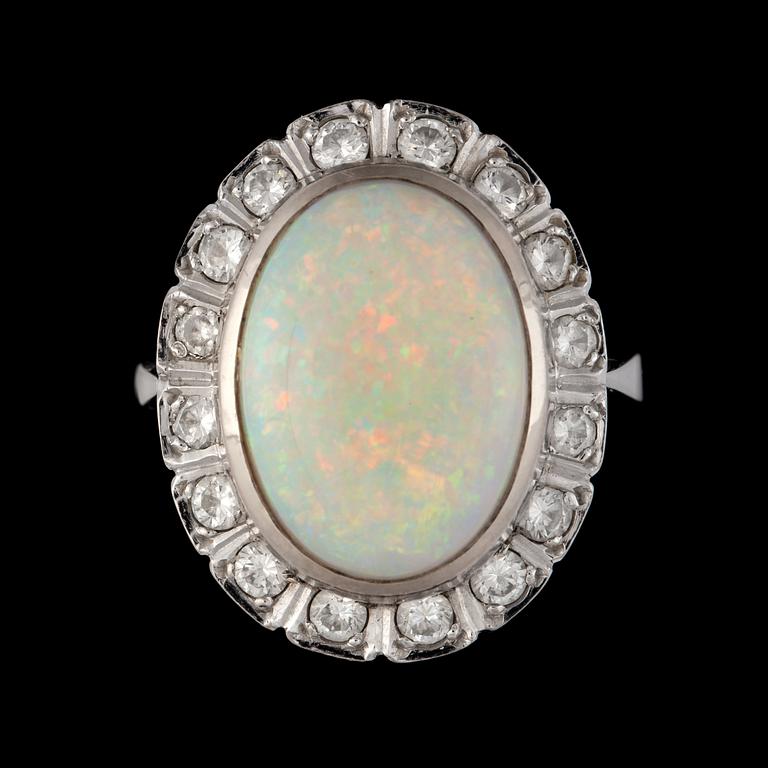 An opal, 9.97 cts, and diamond, 1.00 ct, ring. Weights according to engraving.