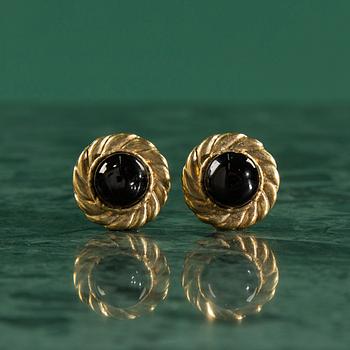 Earclips by Chanel.