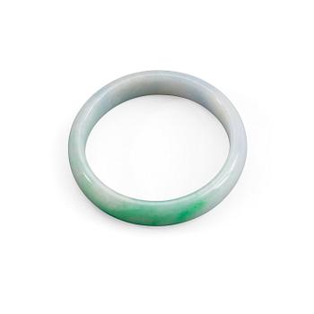 A white and green jadeite bangle with traces of lavender colour, China, 20th Century.