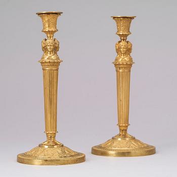 A pair of French Empire early 19th century gilt bronze candlesticks.