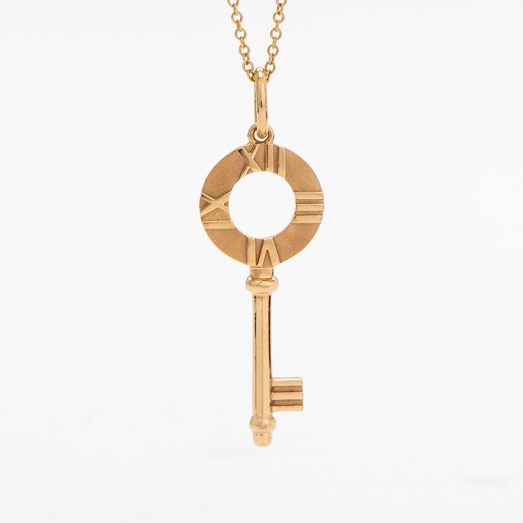 Tiffany & Co, an 18K gold 'Atlas Key' pendant with chain.