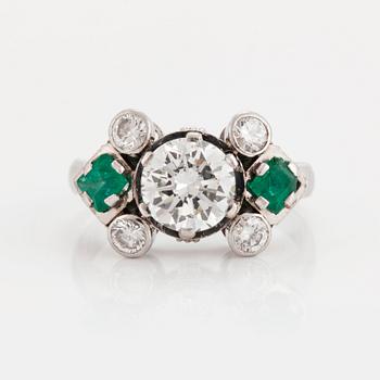 858. A RING set with round brilliant-cut diamonds and carré-cut emeralds.