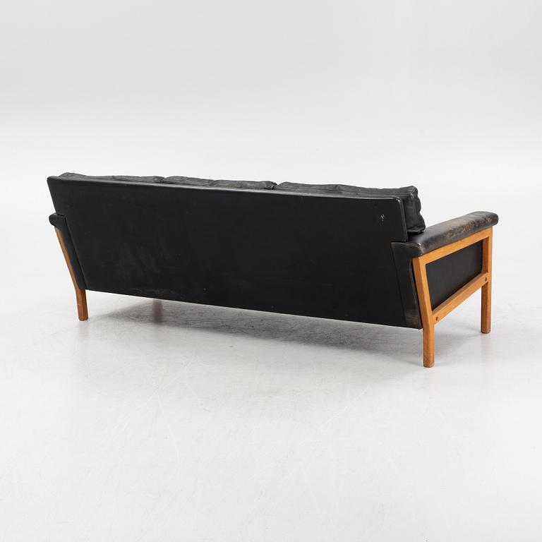 A leather and teak sofa, 1960-70s.