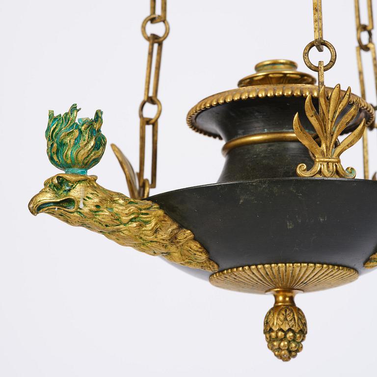 An Empire ormolu and patinated bronze four-light chandelier, Stockholm, early 19th century.