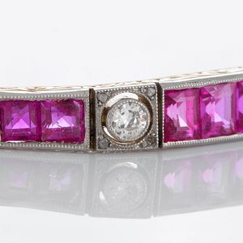 An 18K gold and platinum bracelet set with step-cut rubies and old- and rose-cut diamonds.