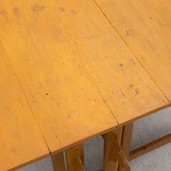 A drop-leaf table, circa 1900.