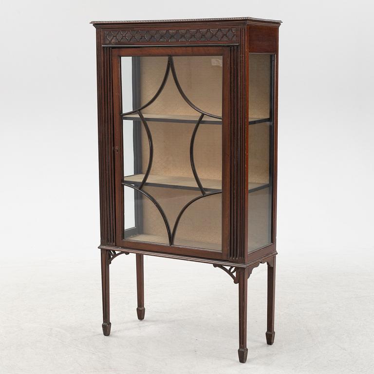 A mahogany vitrine cabinet from around the year.