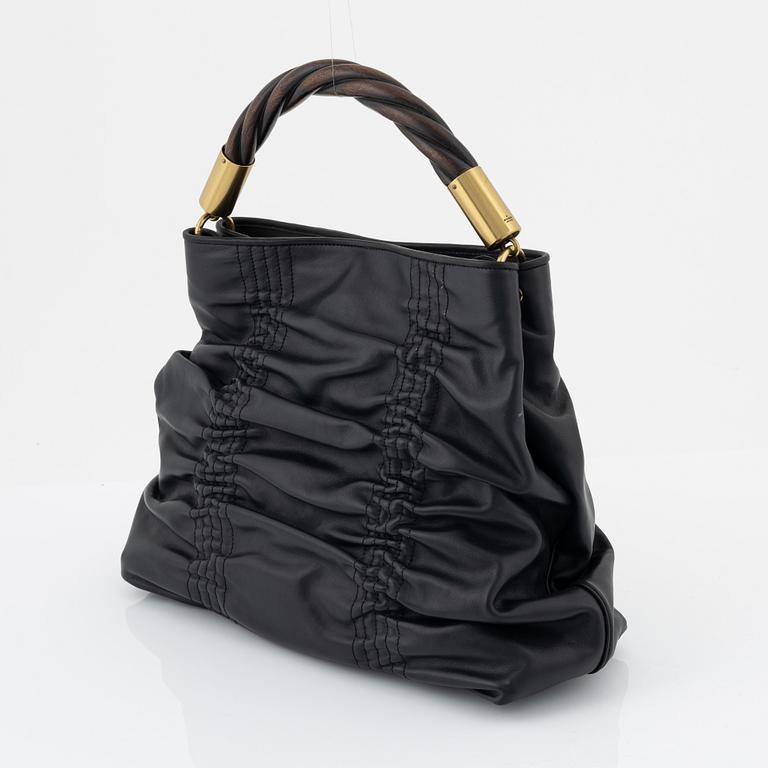 Gucci, a black leather handbag.