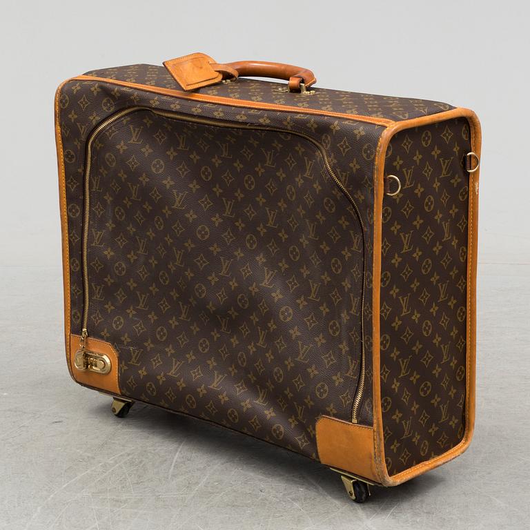 LOUIS VUITTON, a monogram canvas suitcase on wheels.