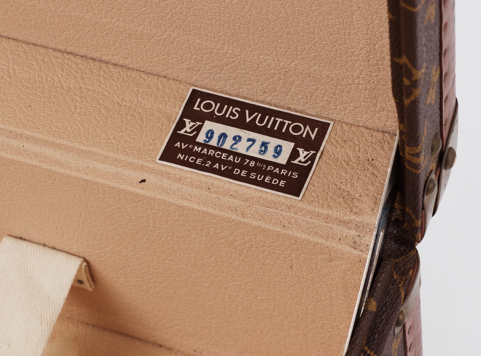 A monogram canvas suitcase by Louis Vuitton.
