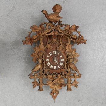 A Black Forest area pendulum wall clock.