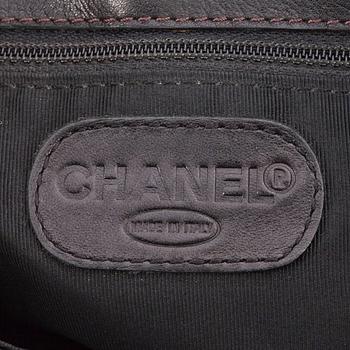 CHANEL, a black leather tote bag.