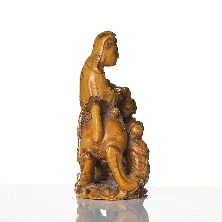 A well carved soapstone sculpture of Guanyin seated on Xiezhai, Qing dynasty, 18th/19th century.