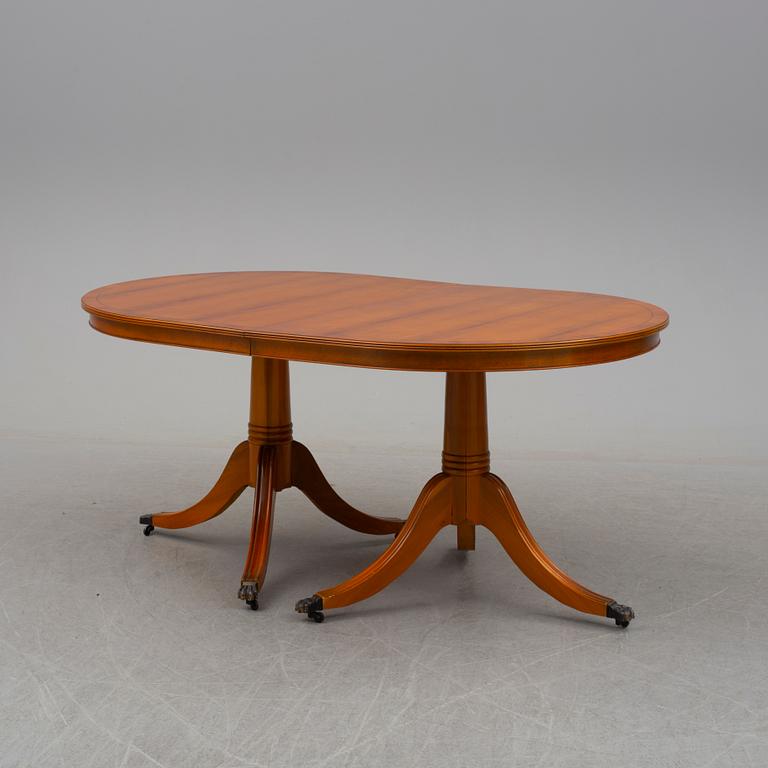 a late 20th century dining table with eight chairs.