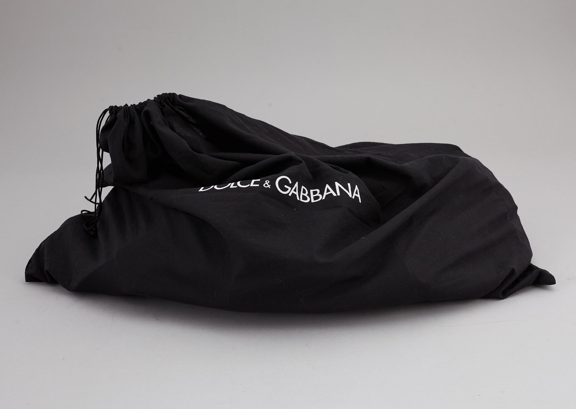 DOLCE & GABBANA, a black leather weekend bag, 2009.