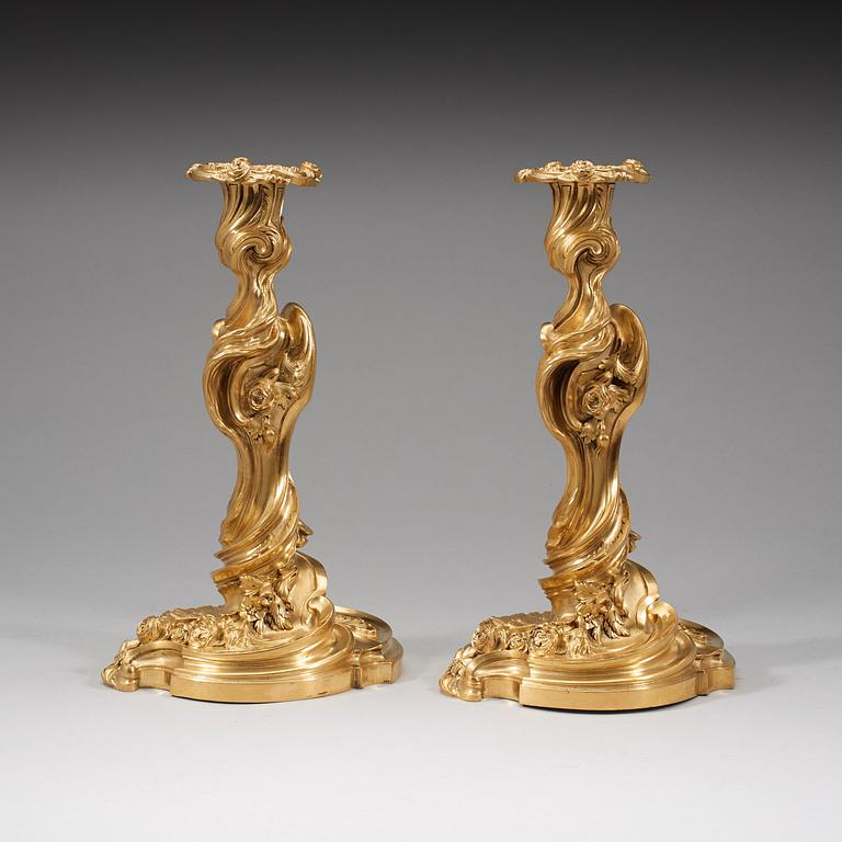 A pair of Louis XV 18th century gilt bronze candlesticks after the model by Juste-Aurèle Meissonnier.