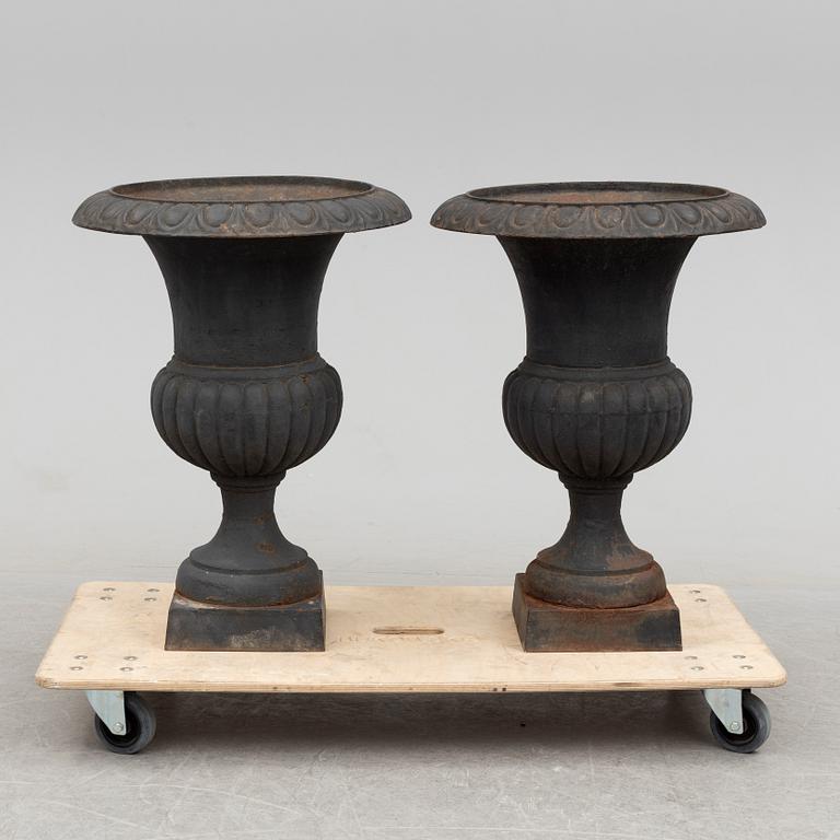 A pair of cast iron plant pots, late 20th century.