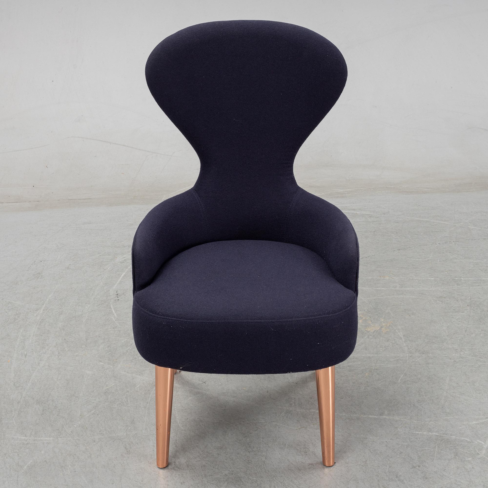 A Tom Dixon "Wingback Dining Chair" from Tom Dixon.