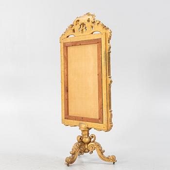 A gilt-wood and embroidered fire screen, second half of the 19th Century.