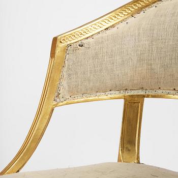 A pair of late Gustavian giltwood open-back armchairs, Stockholm, late 18th century.