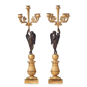 120. A pair of French Empire early 19th century five-light candlesticks.