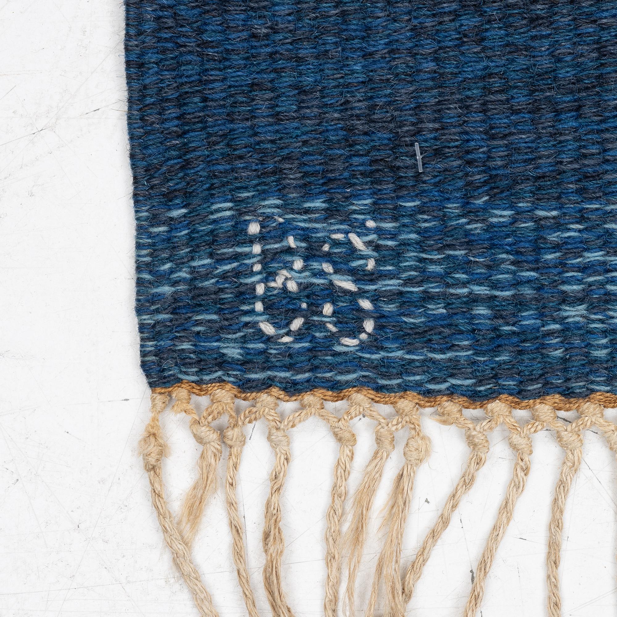 A flat weave carpet, c. 252 x 153 cm signed BS.