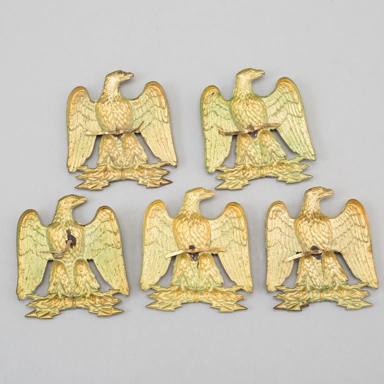 FIVE BRASS UNIFORM EMBLEMS, 19th century.