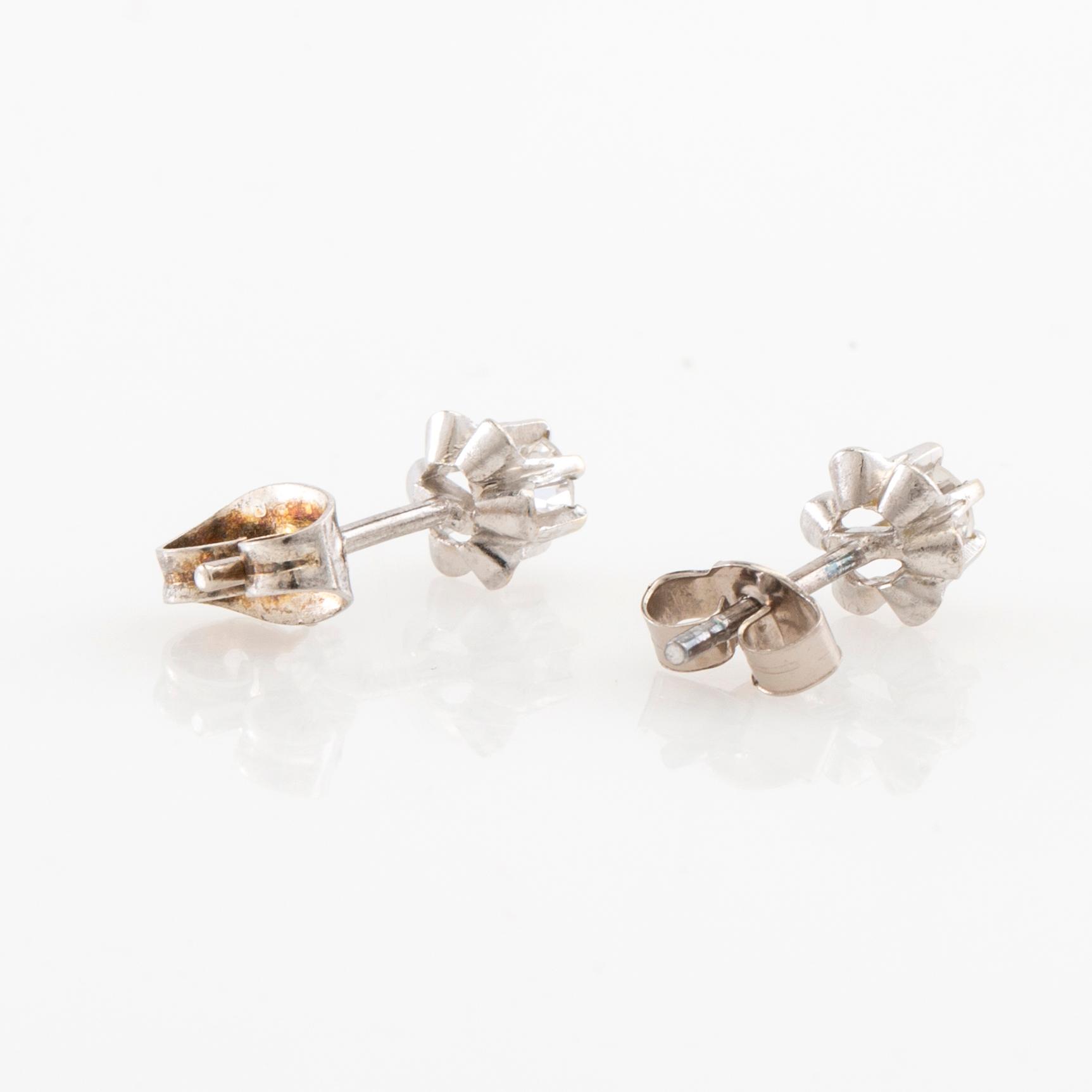 Earrings, a pair of 18K white gold set with round brilliant-cut diamonds.
