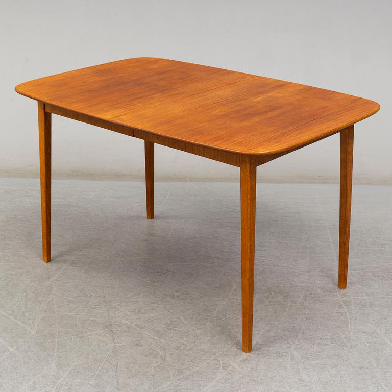 A late 20th Century teak veneered dinner table.