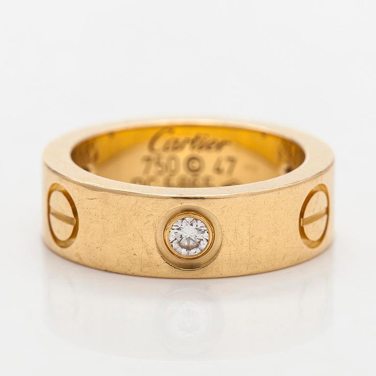 Cartier, an 18K gold 'Love' ring with three brilliant-cut diamonds.