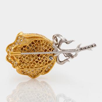 An 18K gold and platinum brooch in the shape of a rose set with eight-cut diamonds.