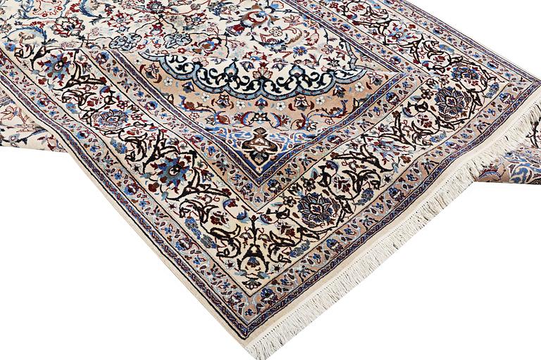 A Nain carpet, part silk, 9 laa, c. 318 x 209 cm.