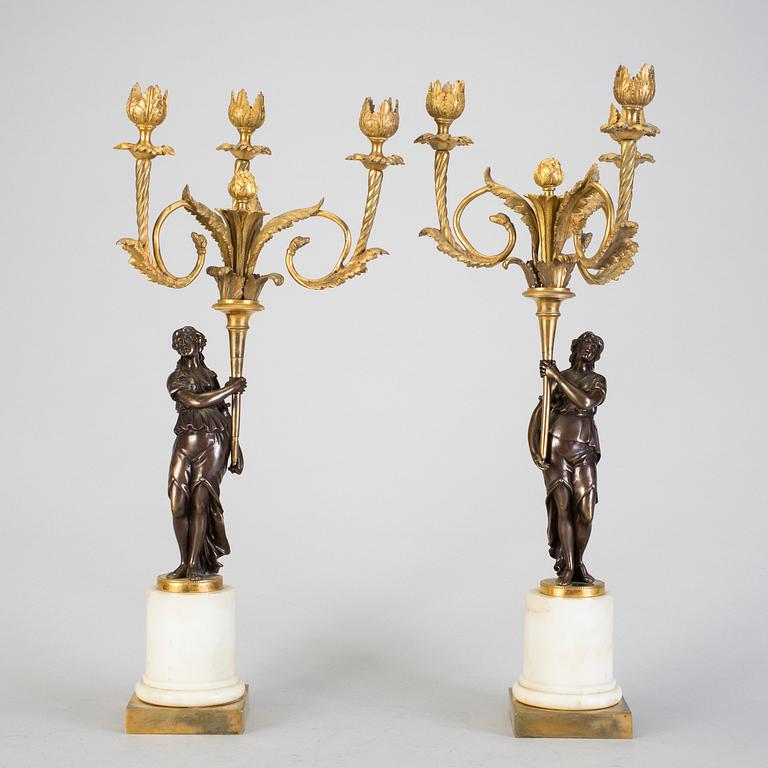 A pair of 19h Century Louis XVI style three-light candelabra in bronze and marble.