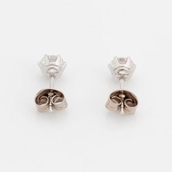 A pair of 18K white gold earrings set with two round brilliant-cut diamonds.