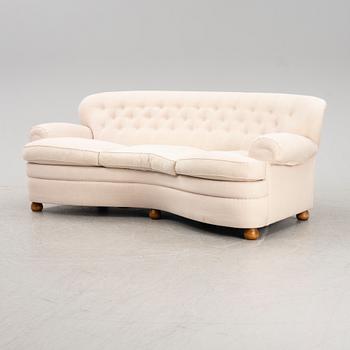 A model 968 curved sofa by Josef Frank for Firma Svenskt Tenn.