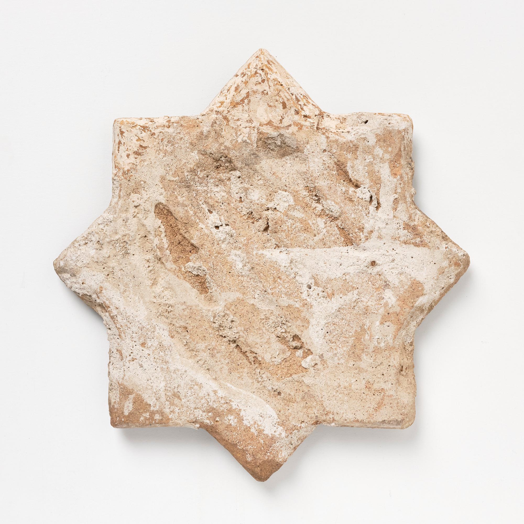 A Qajar moulded figural pottery tile, diameter ca 30 cm.